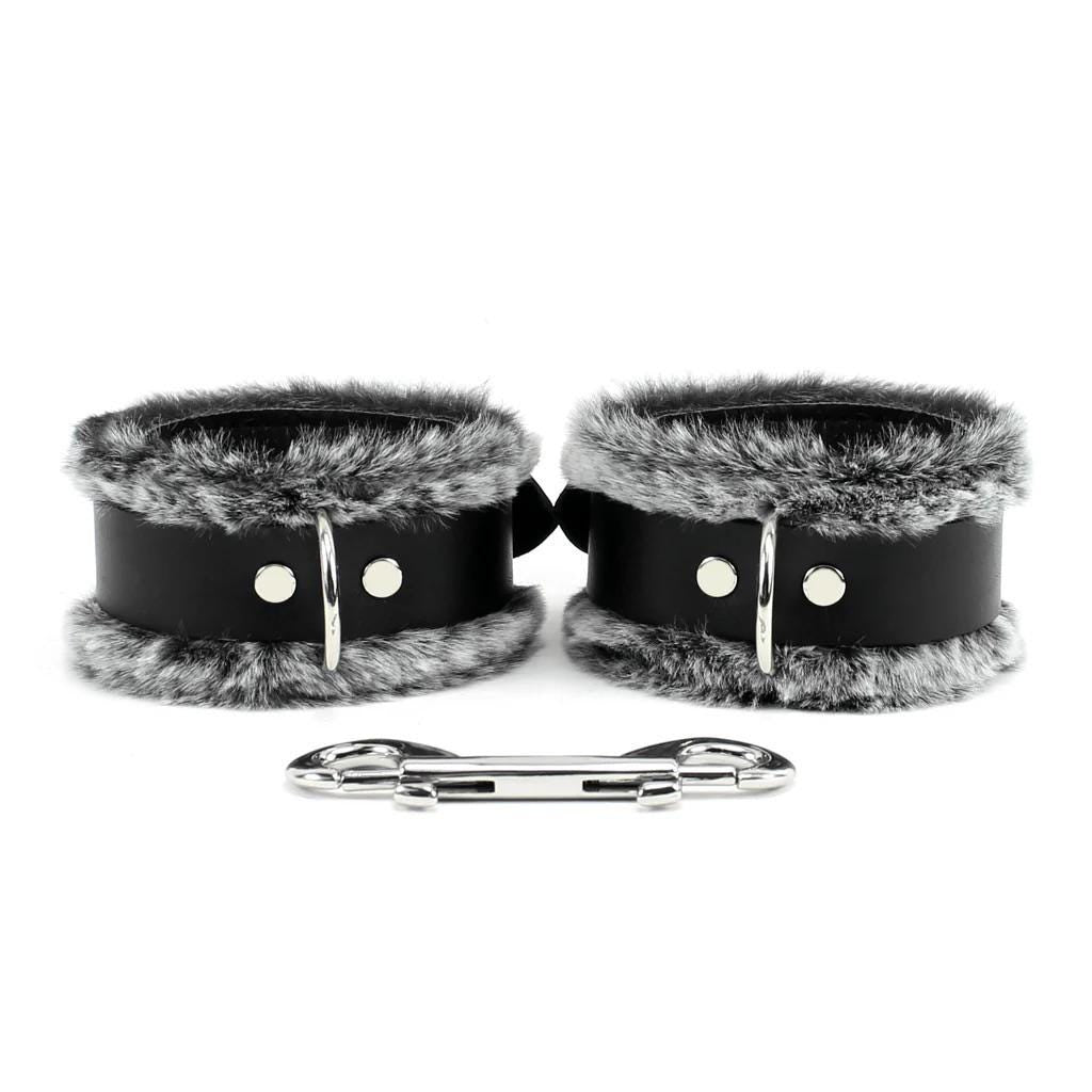 a pair of cuffs and a pair of handcuffs