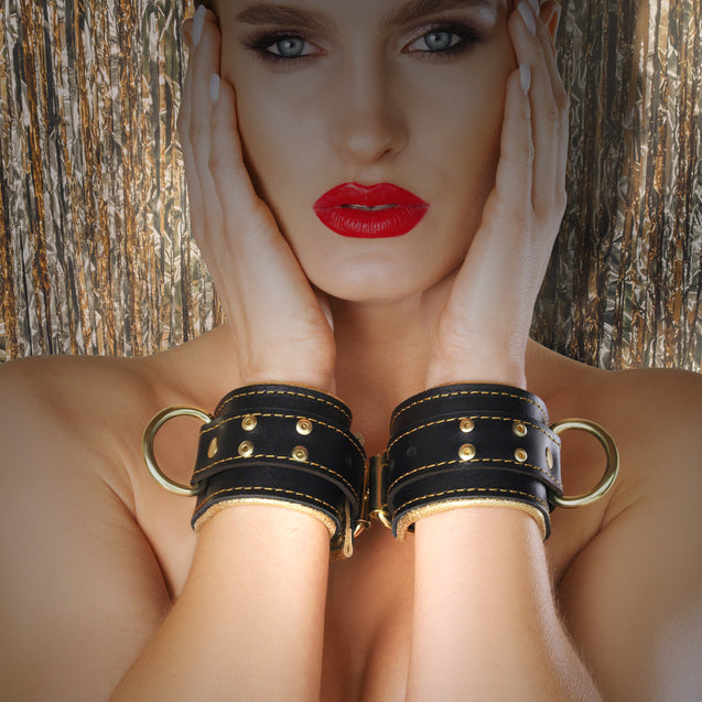 Luxury metallic padded leather bondage cuffs wrist front on model